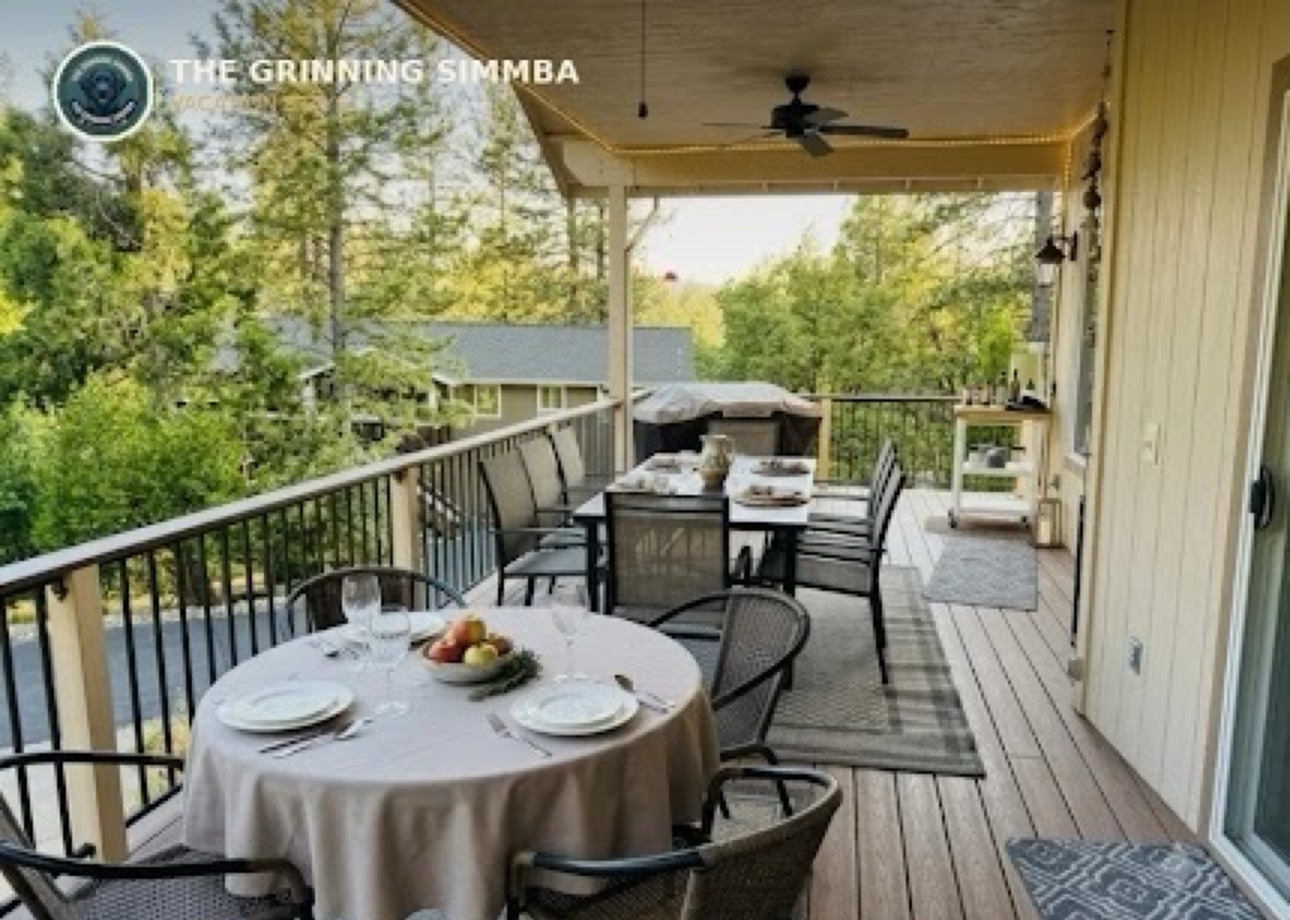 Covered deck with outdoor dining tables among the trees