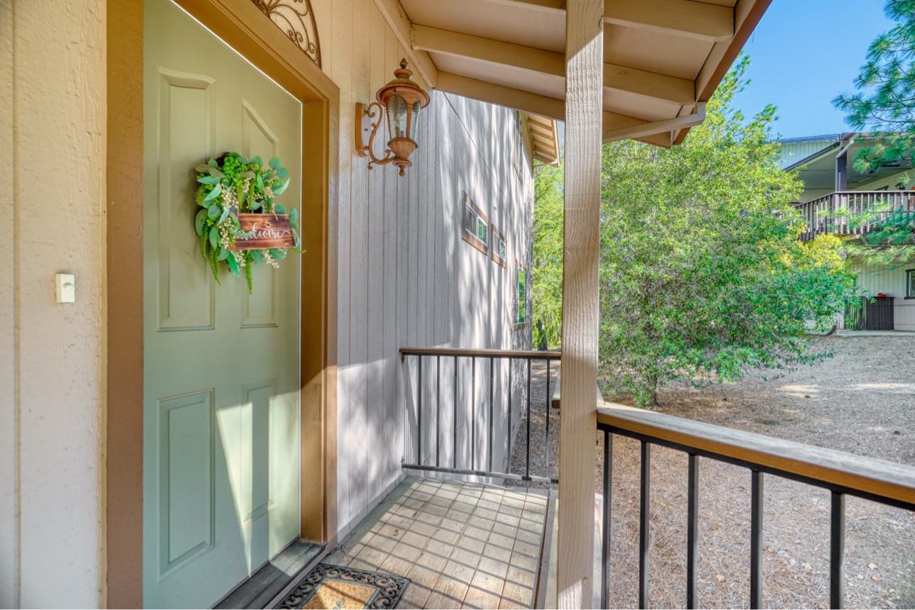 Cabin front entrance with a welcoming green door