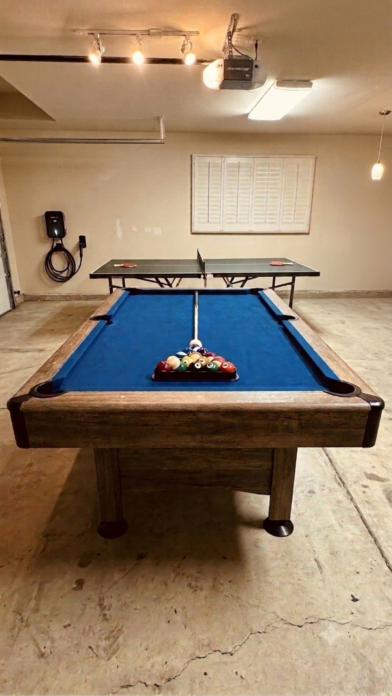 Game room with a pool table and ping pong table